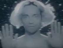 a guru-like man with white hair and shining eyes standing and smiling with his palms open to the viewer, stars moving behind him and wind blowing his hair