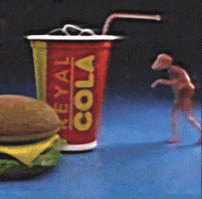 tiny fleshy creature Simon walking towards a hamburger